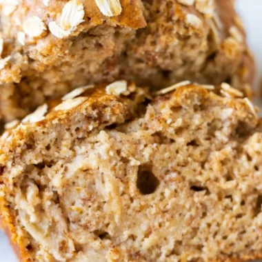 Sliced banana oatmeal bread on a wooden cutting board