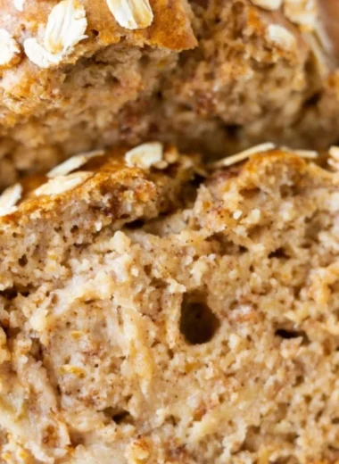 Sliced banana oatmeal bread on a wooden cutting board