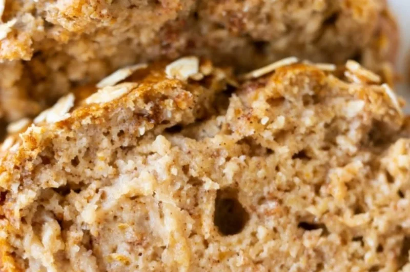 Sliced banana oatmeal bread on a wooden cutting board