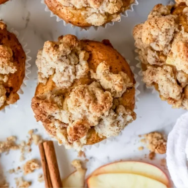 Freshly baked cozy apple crumble muffins with crispy topping.