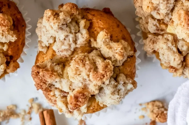 Freshly baked cozy apple crumble muffins with crispy topping.