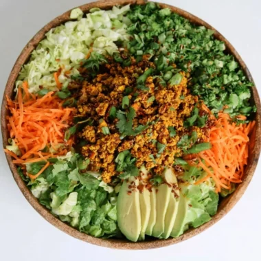 Cozy egg roll salad with colorful veggies and savory sauce in a bowl