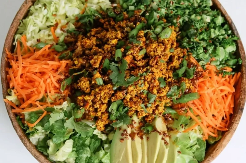 Cozy egg roll salad with colorful veggies and savory sauce in a bowl