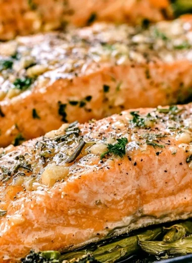 Cozy Garlic Butter Baked Salmon served with herbs and lemon.
