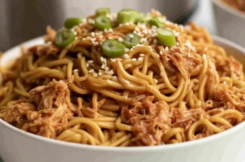 Crockpot honey garlic chicken noodles served with fresh vegetables