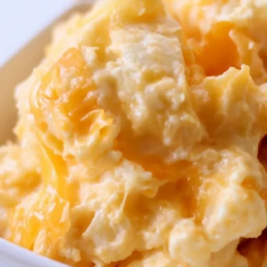 Easy Cheesy Potato Casserole topped with melted cheese and crispy bits.