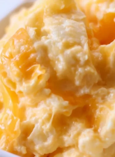 Easy Cheesy Potato Casserole topped with melted cheese and crispy bits.