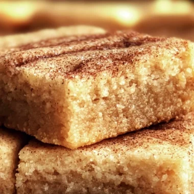 Chewy Snickerdoodle Cookie Bars topped with cinnamon sugar on a rustic plate