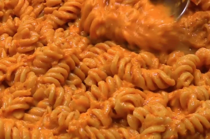 High protein creamy tomato pasta with fresh herbs and cheese