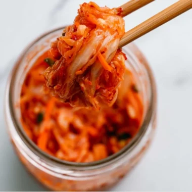 Bowl of homemade kimchi showcasing vibrant red spices and fresh vegetables