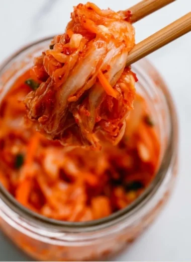 Bowl of homemade kimchi showcasing vibrant red spices and fresh vegetables