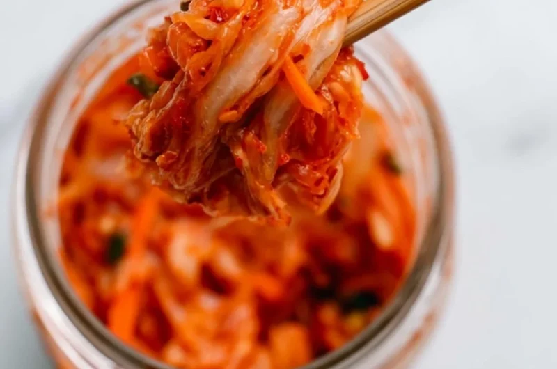 Bowl of homemade kimchi showcasing vibrant red spices and fresh vegetables