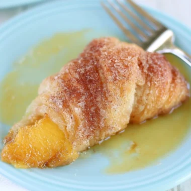 Delicious Peach Cobbler Dumplings topped with cinnamon and served warm