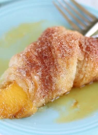 Delicious Peach Cobbler Dumplings topped with cinnamon and served warm