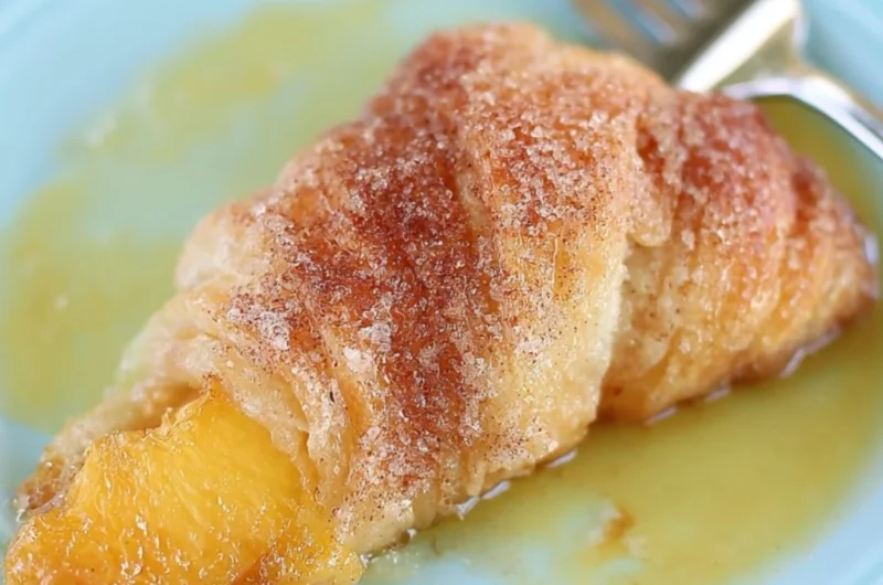 Delicious Peach Cobbler Dumplings topped with cinnamon and served warm