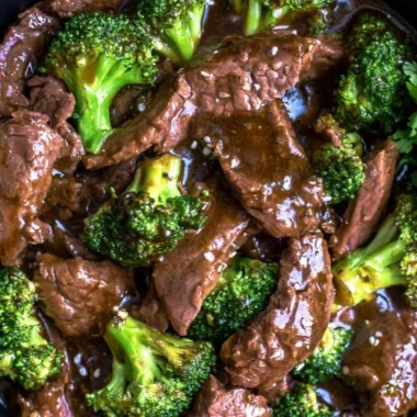 Delicious slow cooker beef and broccoli served on a plate with rice.