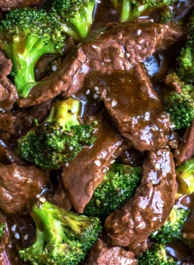 Delicious slow cooker beef and broccoli served on a plate with rice.