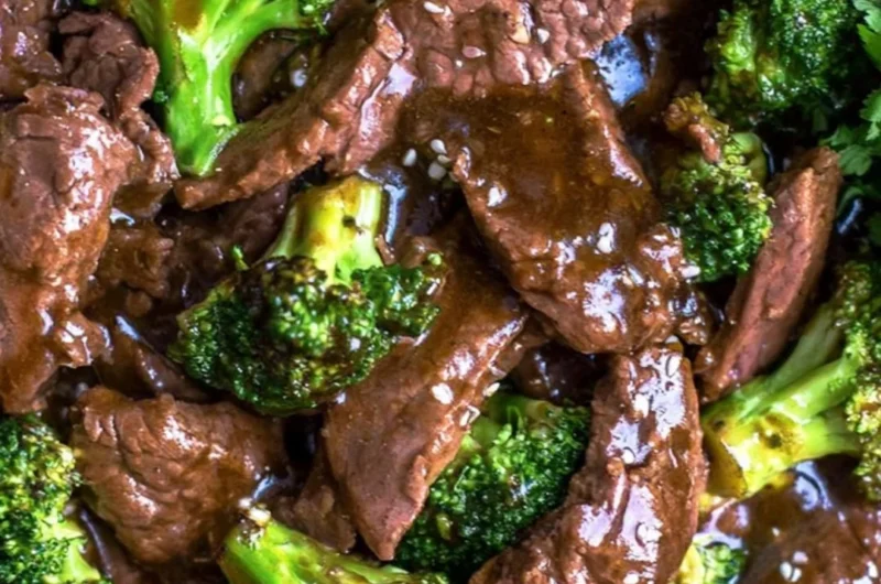 Delicious slow cooker beef and broccoli served on a plate with rice.